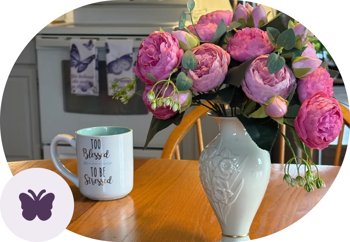 Vase with pink flowers on table